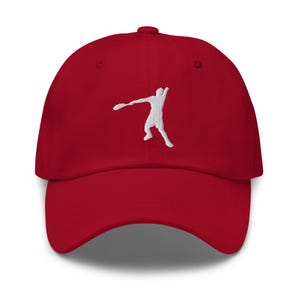 May include: A red baseball cap with a white embroidered silhouette of a person playing tennis.