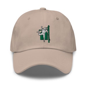 May include: A beige baseball cap with an embroidered design of a person in a green outfit climbing a pole.