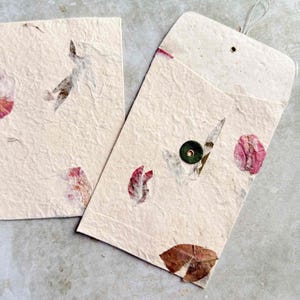 washer and string envelopes made from handmade lokta paper with petals