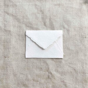 Small rsvp envelope made from white handmade cotton rag paper with deckled edges