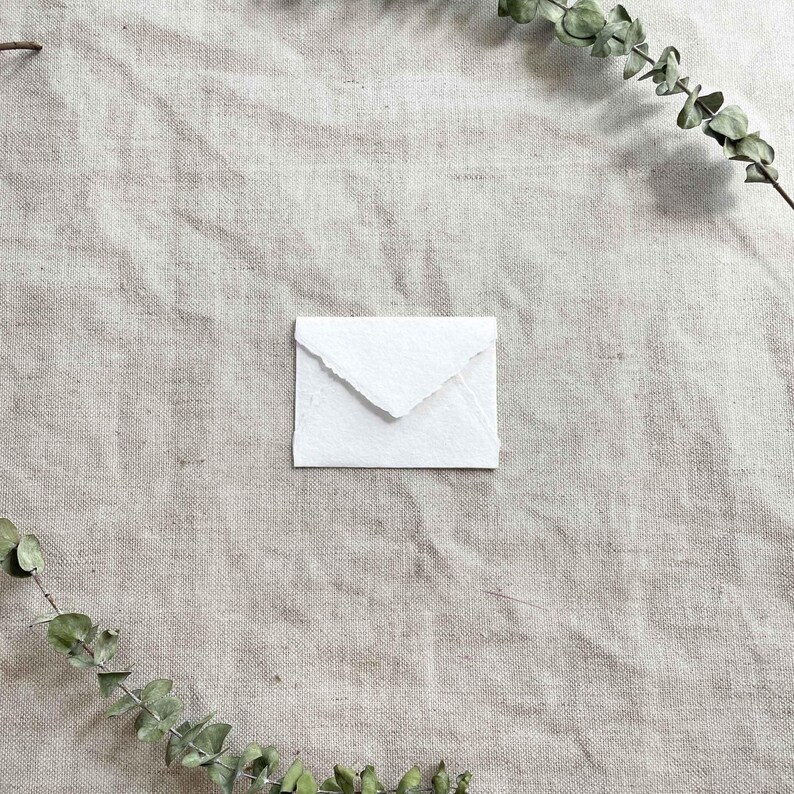 small RSVP envelope made from white handmade cotton rag paper with deckled edges