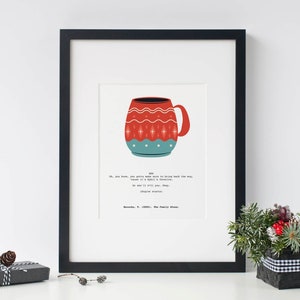 May include: Framed art print featuring a stylized illustration of a red and teal mug with a decorative pattern. The print includes text from the movie "The Family Stone". The artwork is set in a black frame.