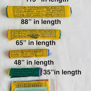 May include: A collection of Tibetan prayer flags in various lengths, from 17 inches to 115 inches. The yellow flags have text, and the green flag is 35 inches long. A packaged flag is also included.