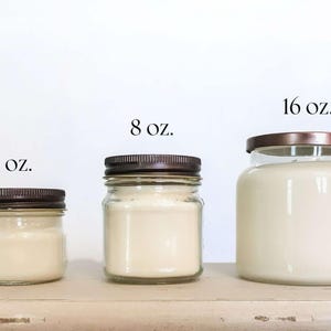 May include: Four glass jars with lids containing candles in various sizes. The jars are labeled 4 oz, 8 oz, and 16 oz.