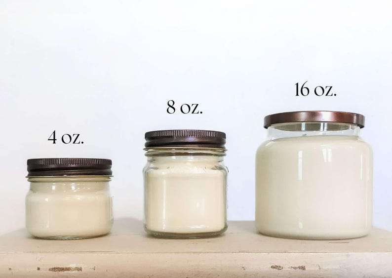 May include: Four glass jars with lids containing candles in various sizes. The jars are labeled 4 oz, 8 oz, and 16 oz.
