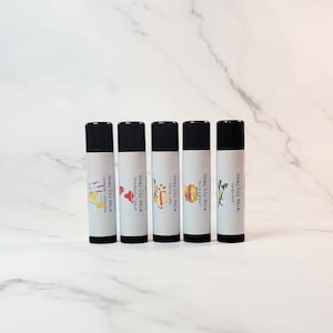 May include: Six black tubes of hemp lip balm with different flavors. The flavors are Lavender Lemonade, Strawberry Dragon, Vanilla Latte, You're a Peach, Vanilla Mint, and Hemp Seed Oil.