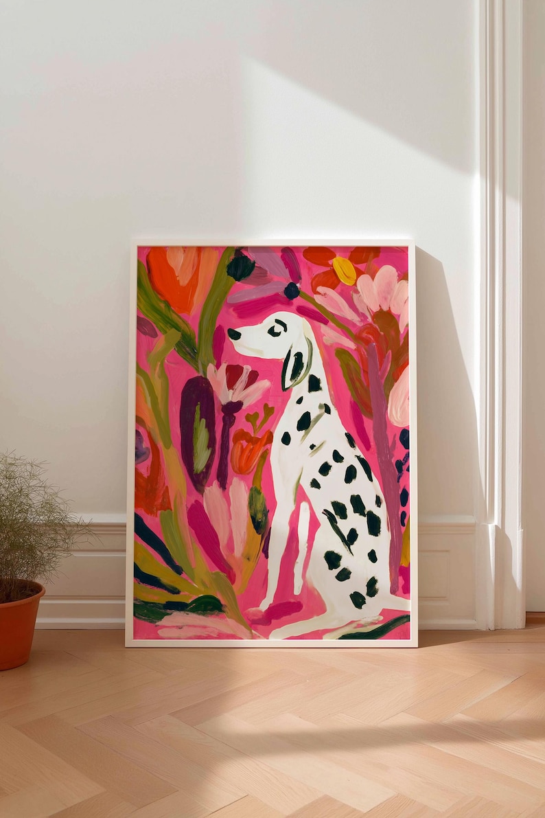 May include: A framed art print featuring a white Dalmatian dog with black spots sitting in a garden of abstract flowers. The background is a vibrant hot pink, with painted floral elements in shades of orange, red, and green surrounding the dog.