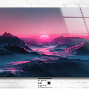 May include: A digital art print of a pink and blue sunset over a mountain range. The sun is a bright pink circle in the sky.