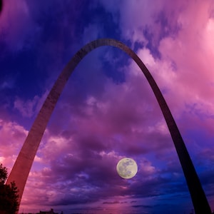 Moon rising under the Gateway Arch in St Louis Missouri L
