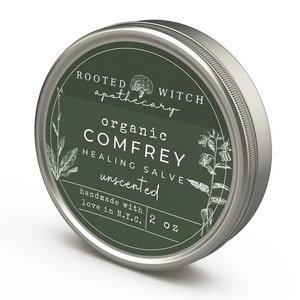 May include: A silver tin with a green label that reads "ROOTED apothecary WITCH organic COMFREY HEALING SALVE unscented handmade with love in N.Y.C. 2 oz".
