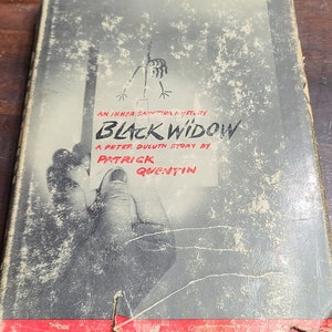 May include: A vintage paperback book cover with a black and white illustration of a stick figure hanging from a rope. The title of the book is "Black Widow" and the author is "Patrick Quentin".