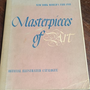 May include: A tan-colored book with the title "Masterpieces of Art" in blue lettering. The book is titled "Official Illustrated Catalogue" and is from the New York World's Fair 1940.