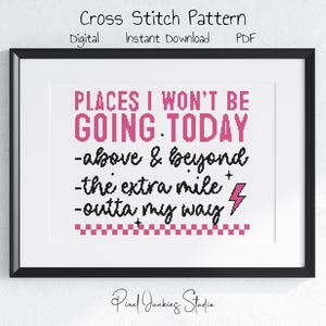 May include: A framed cross-stitch pattern with the text "PLACES I WON'T BE GOING TODAY" in pink and black. The design includes phrases like "above & beyond" and a lightning bolt symbol. The frame is black, and the background is white.