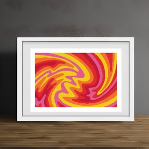 Op de afbeelding: Een ingelijst kunstwerk met een levendig, abstract ontwerp. De afbeelding toont een wervelend patroon in tinten rood, oranje, geel en roze. Het kunstwerk is ingesloten in een witte lijst, wat een moderne esthetiek creëert. Het stuk staat op een houten oppervlak.