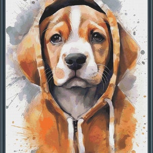 May include: A watercolour painting of a beagle puppy wearing a brown hoodie with a white zip. The background is a white canvas with splashes of orange, grey, and blue paint.