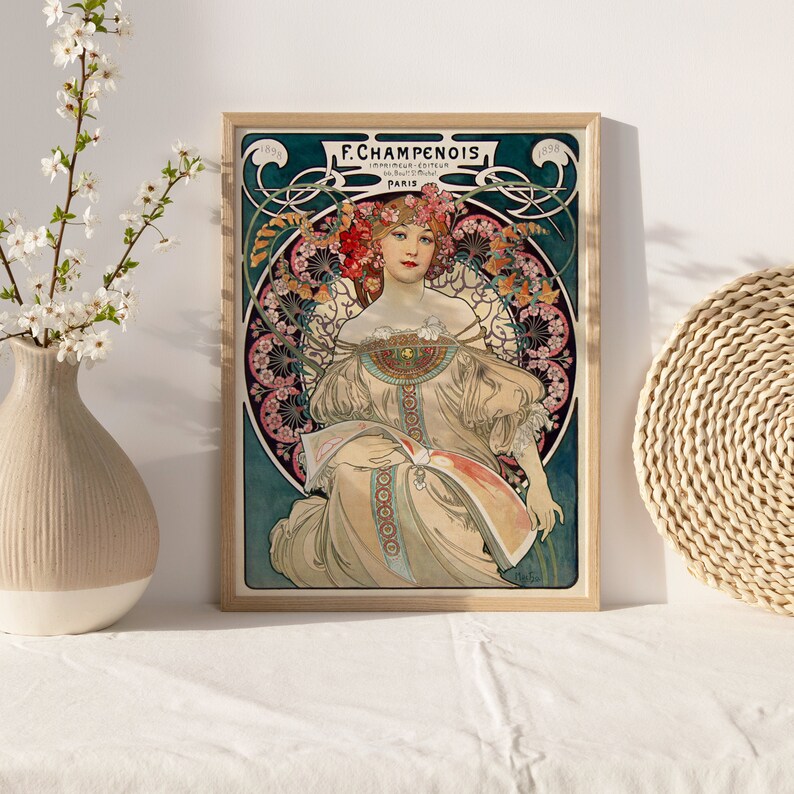 May include: A vintage art nouveau poster featuring a woman in a white dress with a floral crown. The poster is framed in wood and has the text "F. Champenois" and "Paris" on it.