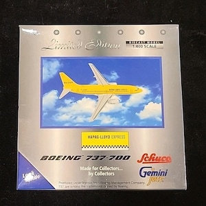 May include: A diecast model of a yellow Boeing 737-700 airplane, labeled "HAPAG-LLOYD EXPRESS," against a blue sky background. The packaging reads "Limited Edition" and "Made for Collectors... by Collectors." The scale is 1:400.
