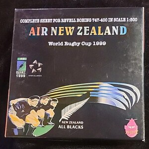 以下が含まれることがあります： 「AIR NEW ZEALAND」と「World Rugby Cup 1999」の文字が入った黒い箱。箱には「COMPLETE SHEET FOR REVELL BOEING 747-400 IN SCALE 1:500」の文字も含まれています。箱にはラグビー選手と様式化された飛行機のイラストが描かれています。