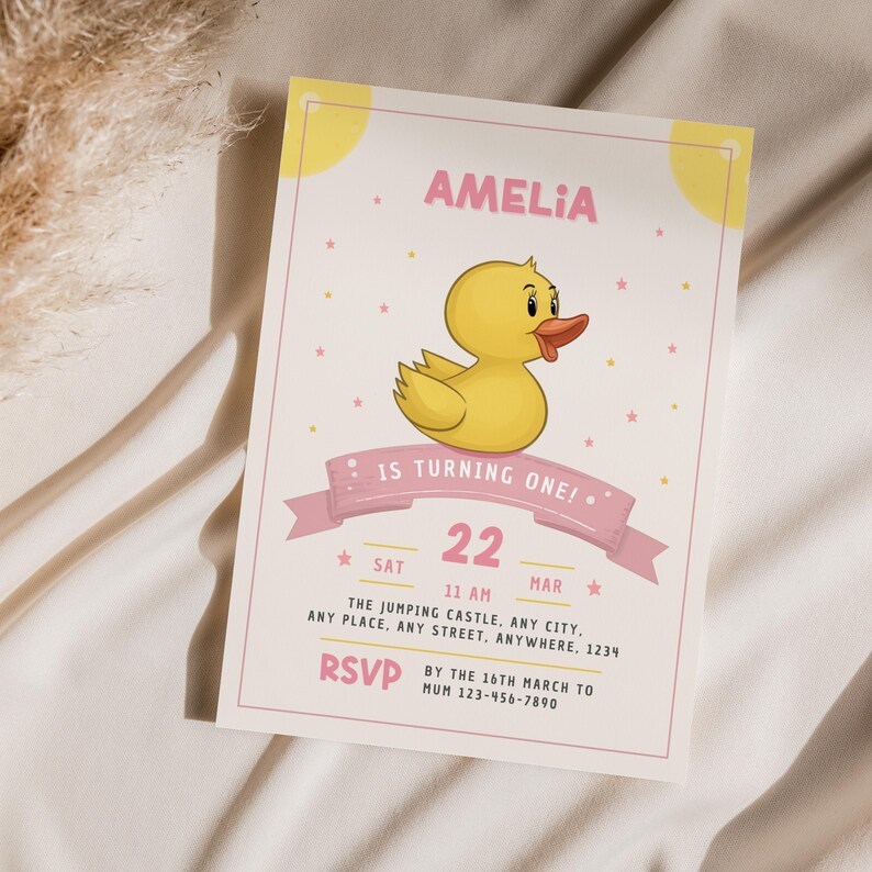 May include: A pink and yellow birthday invitation with a cartoon yellow rubber ducky. The invitation says "Amelia is turning one!" and includes the date and time of the party. RSVP information is also included.