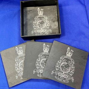 May include: A white ceramic mug with a black handle and the text "But First, Coffee" in a handwritten style. The mug is on a white surface. The mug is 10 cm tall.