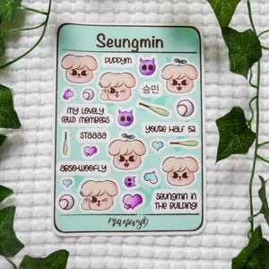 May include: A rectangular sticker sheet with a light green background featuring cartoon puppy illustrations, baseballs, bats, and hearts. Text includes Seungmin, Puppym, My Lovely (ew) Members, Staaaa, Abso-woofly, You're Half 52, and Seungmin In The Building.