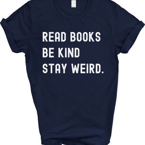 May include: Navy blue t-shirt with white text that reads "Read Books Be Kind Stay Weird."