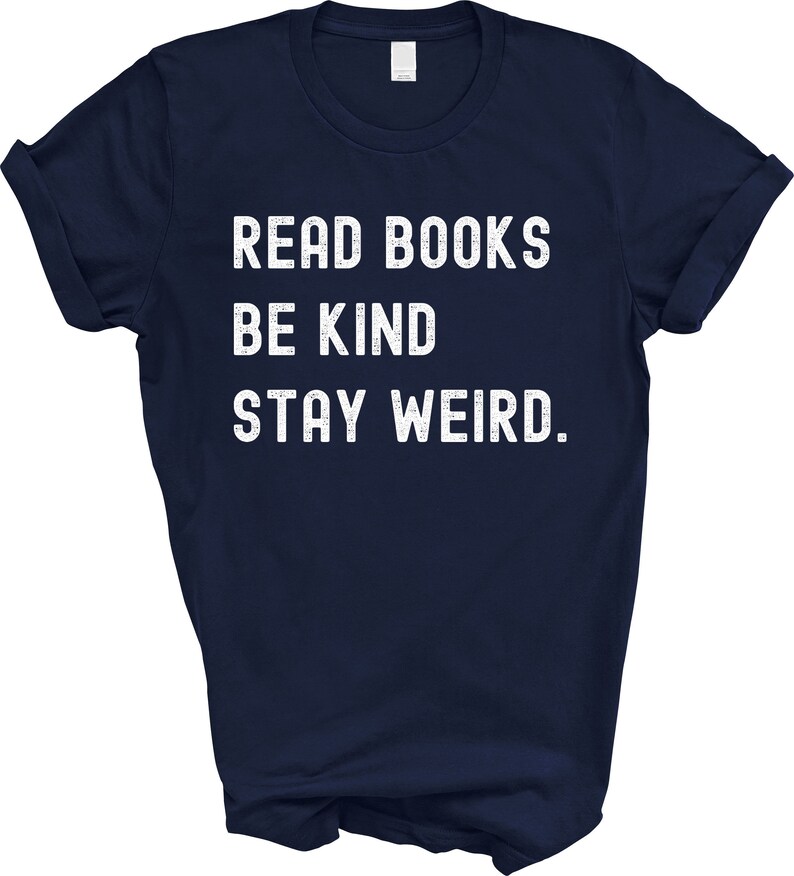 May include: Navy blue t-shirt with white text that reads "Read Books Be Kind Stay Weird."