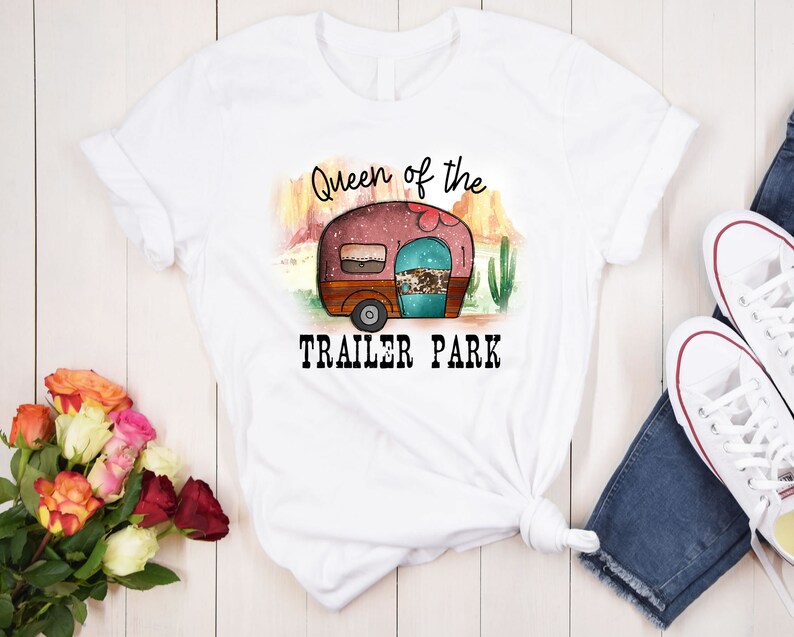 May include: White t-shirt with a graphic of a vintage camper and the text "Queen of the Trailer Park".