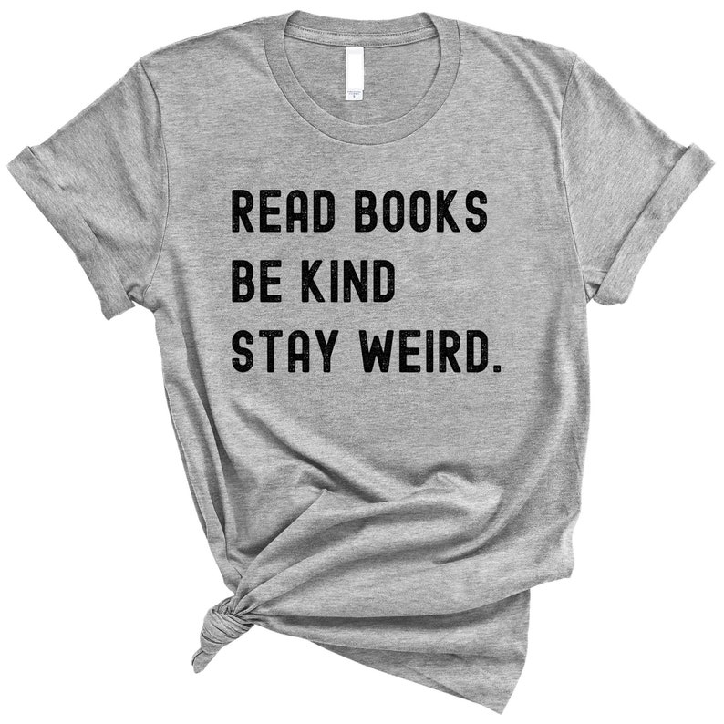 May include: Gray t-shirt with the text "Read Books Be Kind Stay Weird."