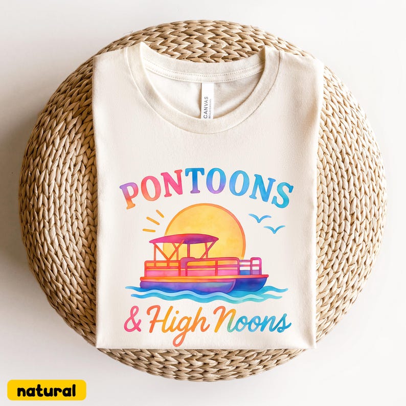 May include: Cream-colored t-shirt with the words "Pontoons & High Noons" in colorful lettering. The design includes a pontoon boat, sun, and birds. The shirt is made of a soft material and is perfect for a day on the water.