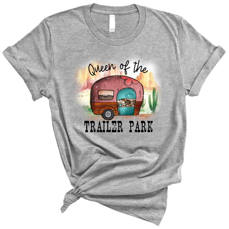 May include: Gray t-shirt with a graphic of a vintage camper in a desert landscape. The text "Queen of the Trailer Park" is printed below the camper.