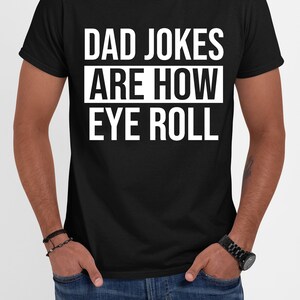 May include: Black t-shirt with white text that reads "Dad Jokes Are How Eye Roll".
