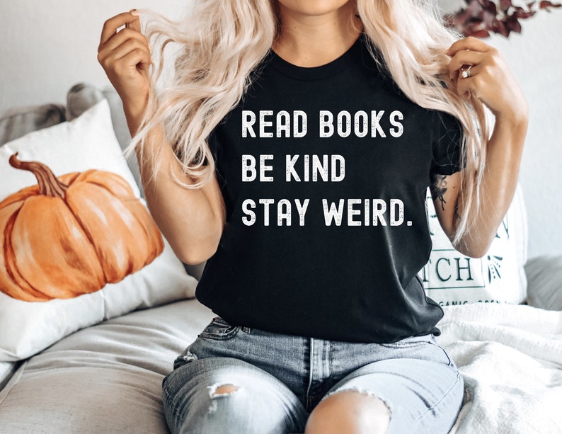 May include: A black t-shirt with white text that reads "Read Books Be Kind Stay Weird."