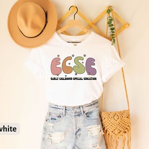 K&ouml;nnte beinhalten: Wei&szlig;es T-Shirt mit einer Grafik der Buchstaben "ECSE" in bunten, abgerundeten Formen mit Sternen. Der Text "EARLY CHILDHOOD SPECIAL EDUCATION" steht unter den Buchstaben.