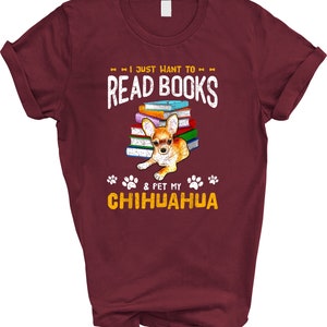 May include: Burgundy t-shirt with a distressed graphic design that says "I just want to read books & pet my chihuahua". The graphic also features a chihuahua sitting on a stack of colorful books.