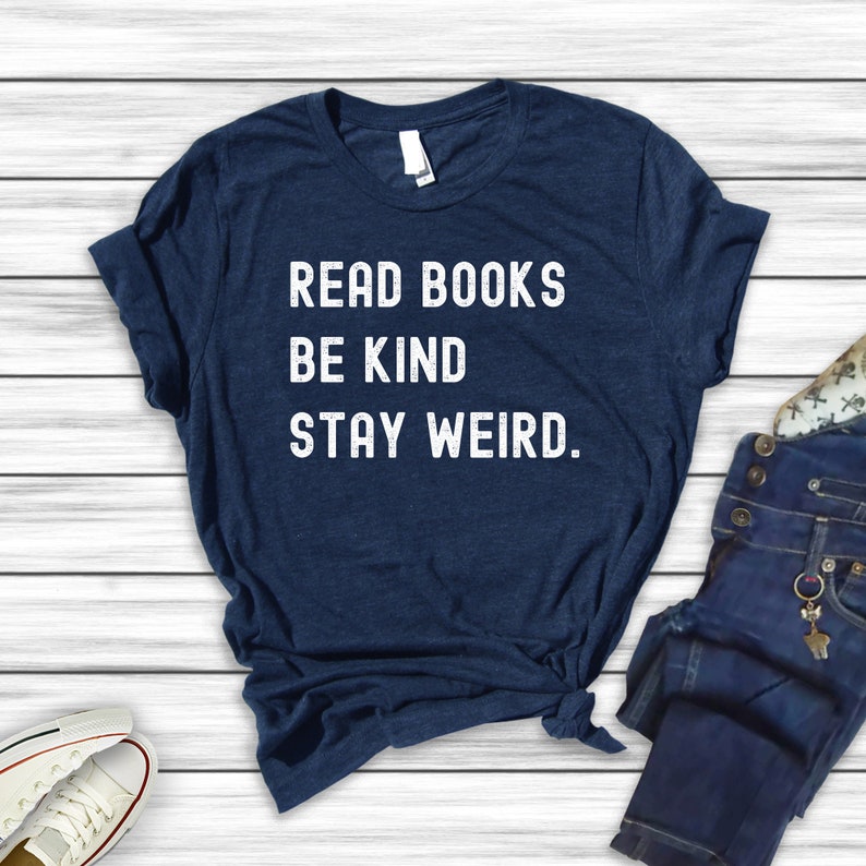 May include: A navy blue t-shirt with white text that reads "Read Books Be Kind Stay Weird."