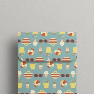 May include: A blue and white patterned gift wrap with beach-themed icons like beach balls, ice cream cones, sunglasses, and buckets. The pattern is repeated throughout the paper.