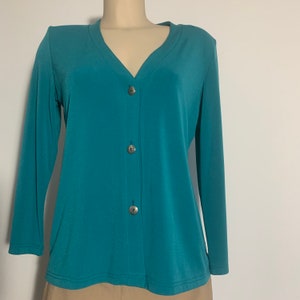 Second hand Jersey V neck top with shoulder pads & three metallic buttons at the front in turquoise color