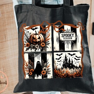 May include: Black tote bag featuring a Halloween-themed design. The design includes a jack-o'-lantern, a ghost, a haunted house, and the words "Spooky Season". The artwork is framed with a brown border and includes bats.