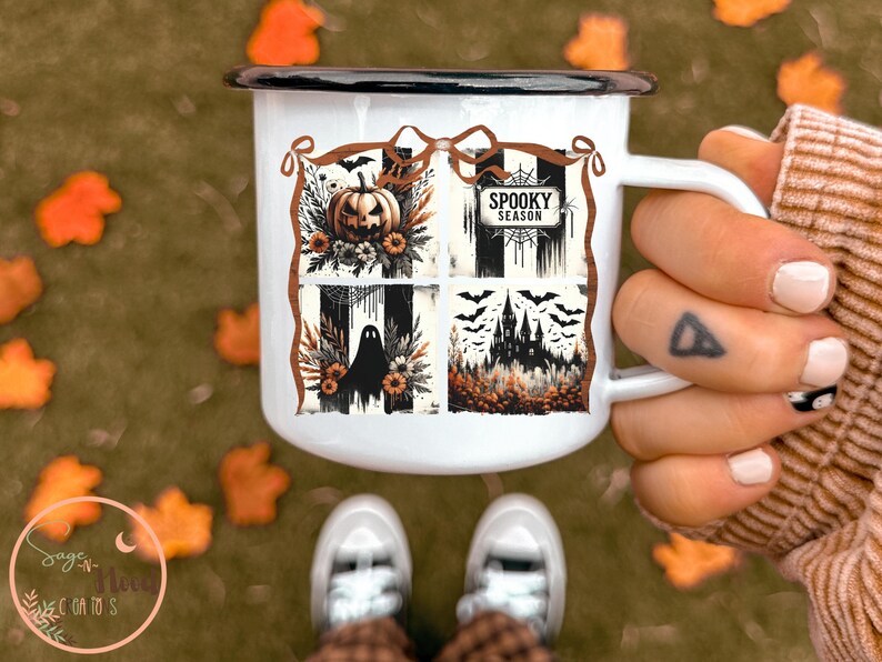 May include: White enamel mug with a black rim and handle. The mug features a Halloween-themed design with a pumpkin, bats, a ghost, and a haunted house. The words "Spooky Season" are also displayed on the mug.