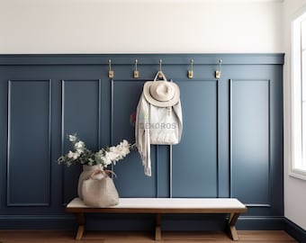 May include: A white hat hangs on a brass hook against a wall with blue wainscoting. A white bench with a white top sits in front of the wall. A vase with white flowers sits on the bench.