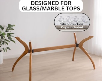 May include: A wooden table base with four curved legs and a central support beam. The text reads DESIGNED FOR GLASS/MARBLE TOPS and Silicon Suction Cups Included, with an inset showing four clear suction cups for attachment.
