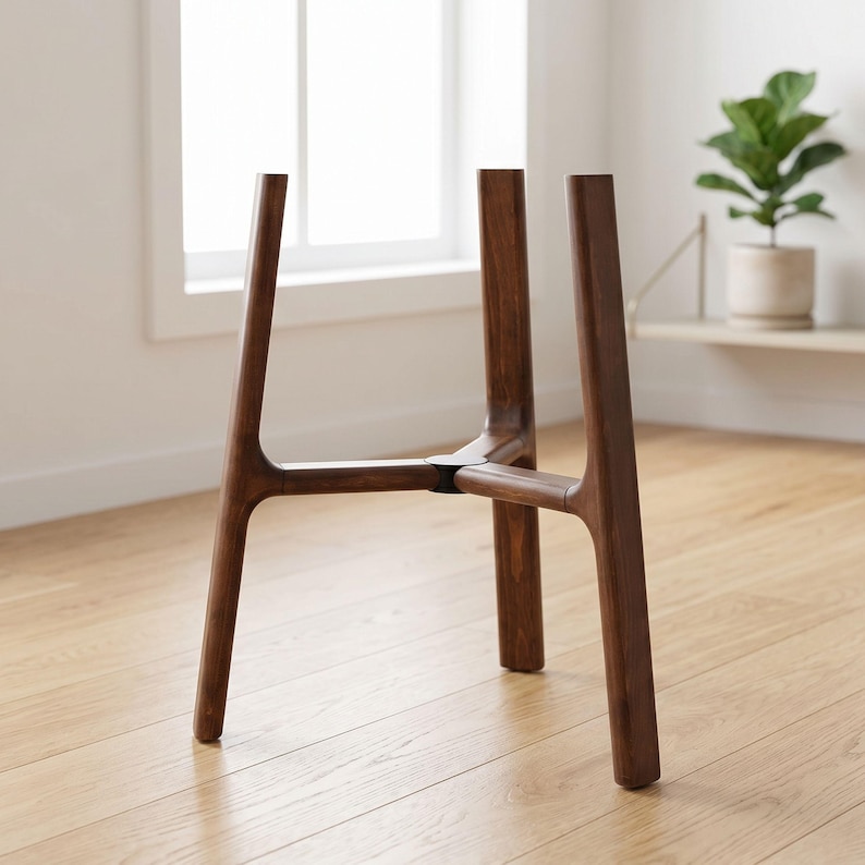 May include: A dark brown wooden plant stand featuring three vertical legs connected by a central horizontal support structure. The stand has a smooth, polished finish and a sturdy, geometric design intended to hold a container or pot securely.