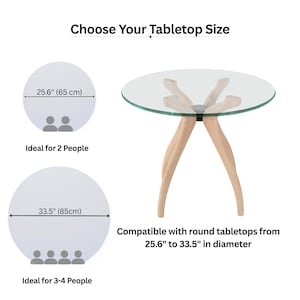 May include: A modern round glass tabletop with light wood legs. The image includes text that reads "Choose Your Tabletop Size" and "Compatible with round tabletops from 25.6" to 33.5" in diameter."