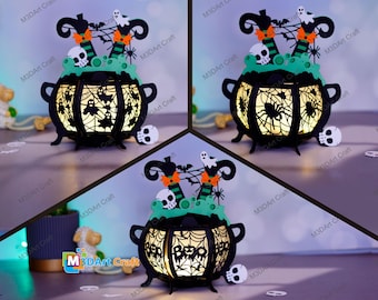 May include: A black Halloween cauldron-shaped lantern with a spiderweb design, skulls, and witch legs. The lantern has a green base and is lit from within. The text "Boo" is visible on the front. The product is from M3DArt Craft.
