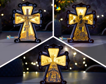 May include: Three illuminated wooden cross-shaped light-up decorations with different religious scenes. The first cross features a depiction of Jesus on the cross, the second cross features a dove and flowers, and the third cross features a nativity scene.