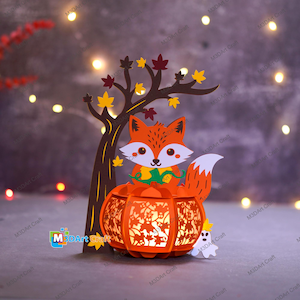 May include: A papercraft autumn scene featuring a fox, a tree, and a pumpkin lantern. The orange fox has a white face and tail, and sits atop a carved pumpkin. The tree has brown bark and colorful leaves. A small white ghost is also present.