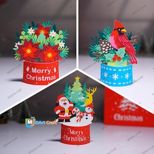 May include: A collage of three Christmas paper craft decorations. One shows red poinsettias, another a red cardinal, and the third Santa Claus, a snowman, and a Christmas tree. Each design sits on a cylindrical base with "Merry Christmas".