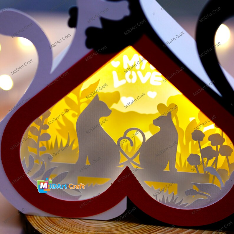 May include: A white and red heart-shaped wooden box with a light inside. The box has a cutout design of two cats sitting on a bench with a heart between them. The text "My Love" is visible in the center of the box.