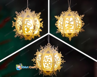 May include: Three white paper snowflake ornaments with intricate cutouts. Each ornament is illuminated from within, casting a warm glow. The ornaments are suspended from white strings.
